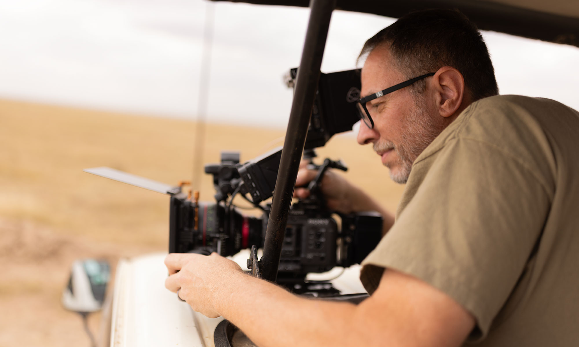Filmmaker Chris Tinard operating a cinema camera during production in Kenya