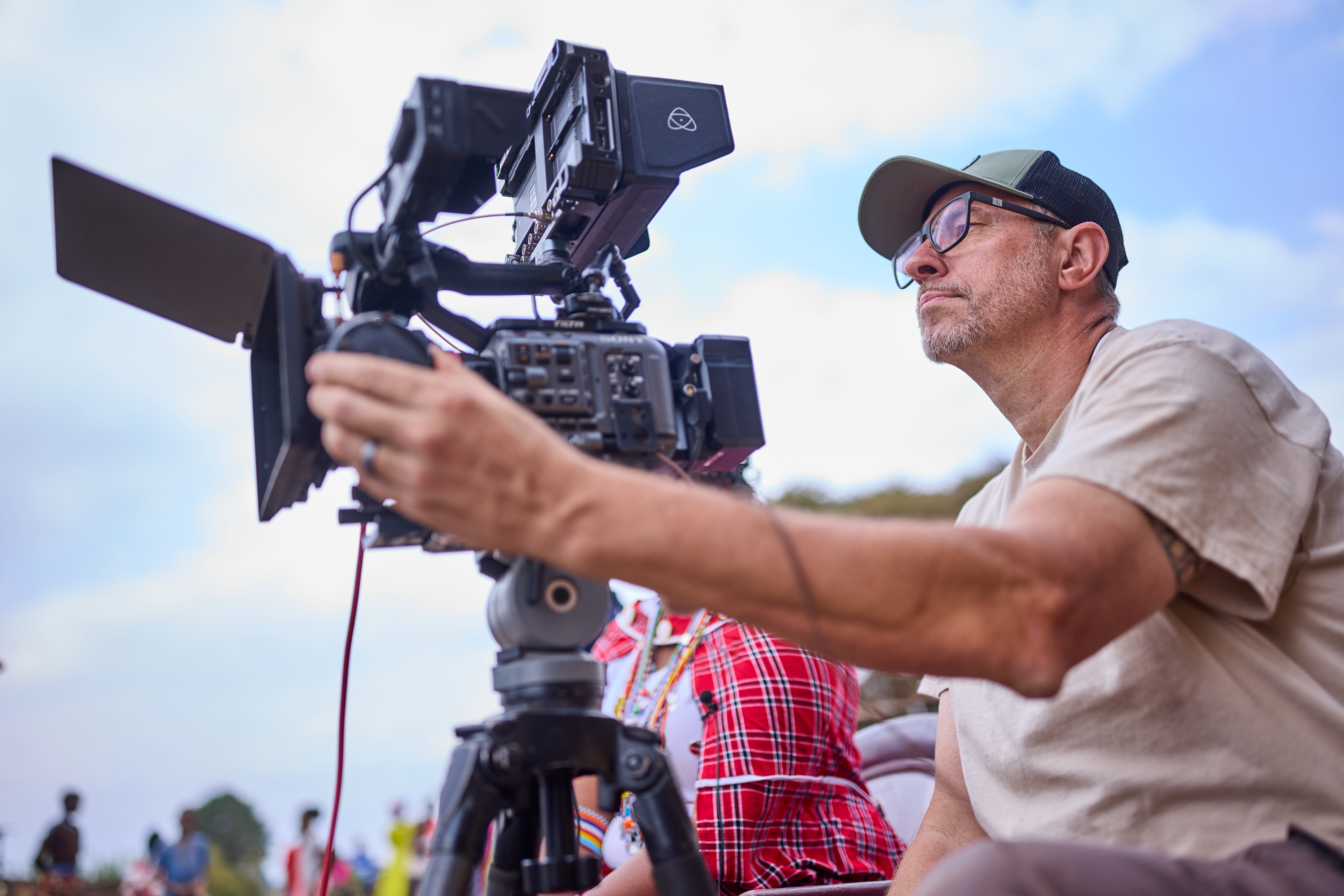 Filmmaker Chris Tinard operating a cinema camera during documentary production